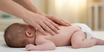Gentle hands massaging a baby's back on a soft blanket, promoting relaxation and connection.