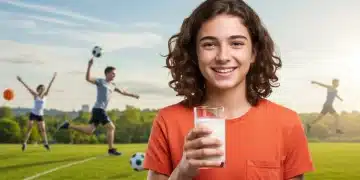 Teenager smiling, holding milk, representing healthy calcium intake for strong bones.